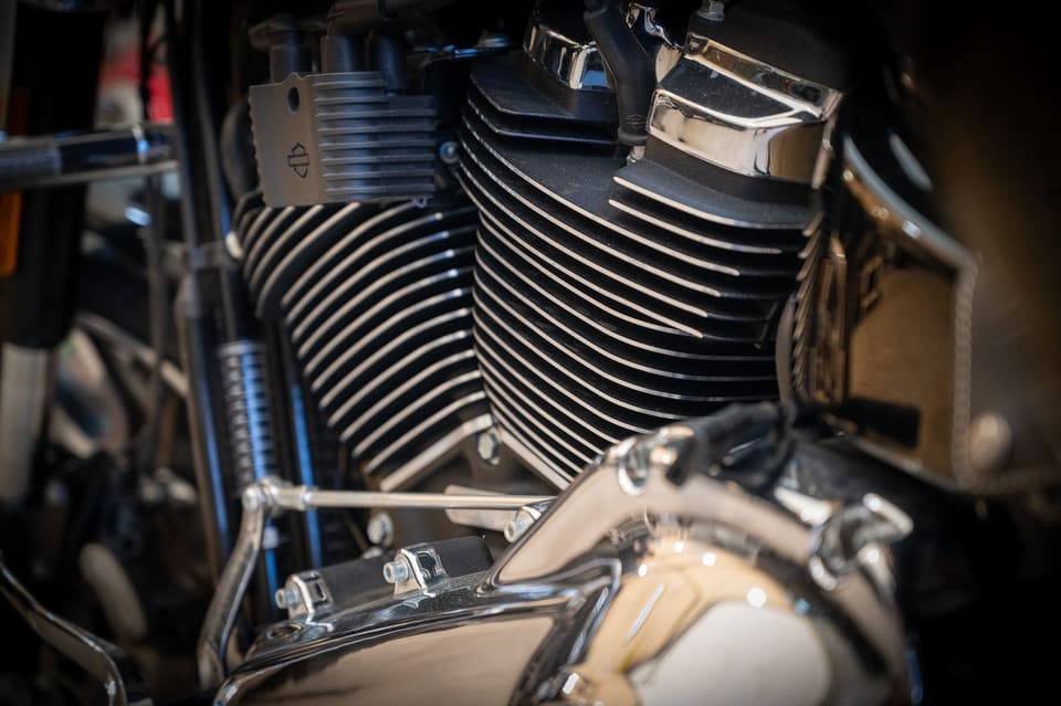 Close-up of a Harley-Davidson V-twin engine with chrome and black cylinder fins.